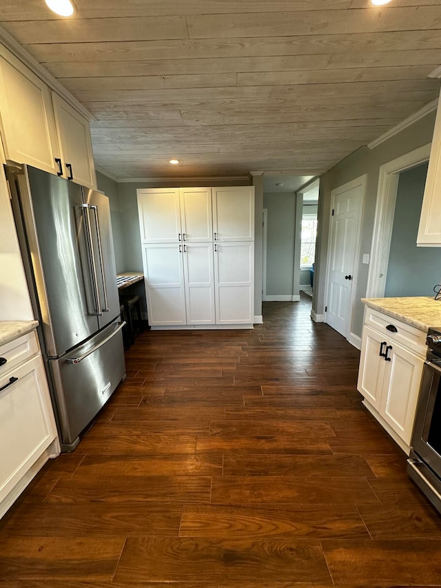 kitchen with white cabinets, dark hardwood / wood-style floors, light stone countertops, appliances with stainless steel finishes, and wood ceiling