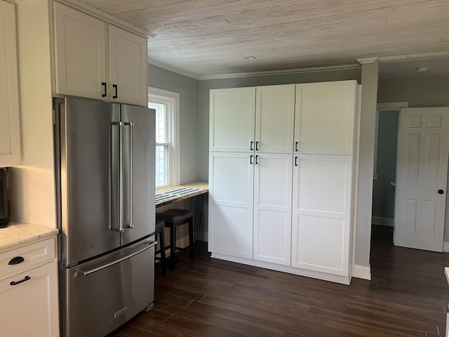 kitchen featuring high quality fridge, dark hardwood / wood-style flooring, white cabinets, and ornamental molding