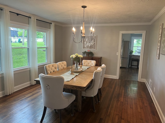 dining area with dark hardwood / wood-style flooring, ornamental molding, a textured ceiling, and an inviting chandelier