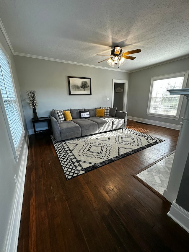 living room featuring a textured ceiling, dark hardwood / wood-style floors, ceiling fan, and crown molding