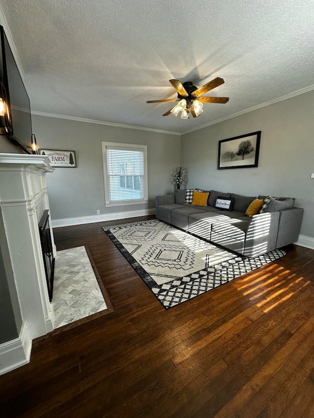 living room with dark hardwood / wood-style floors, ceiling fan, and a textured ceiling