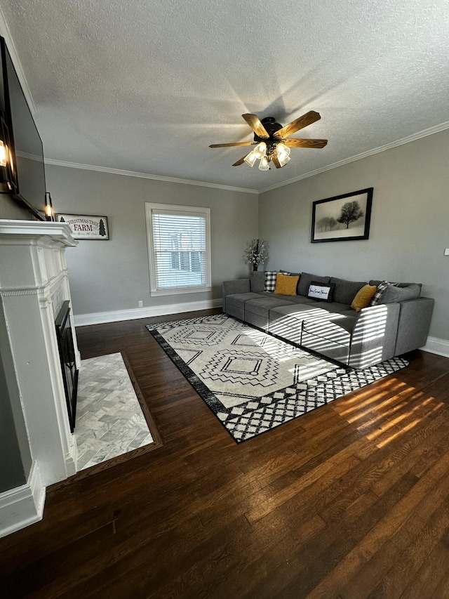 2458 High Bridge Rd, Lancaster, KY 40444 - living room featuring dark wood-style flooring, ceiling fan, a textured ceiling, baseboards, and crown molding