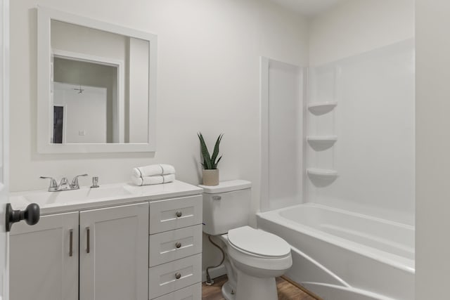 full bathroom with bathing tub / shower combination, hardwood / wood-style flooring, vanity, and toilet