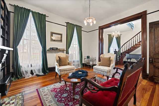 sitting room featuring hardwood / wood-style floors, an inviting chandelier, and plenty of natural light