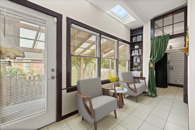 sitting room featuring light tile patterned floors and a skylight