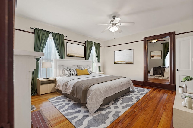 bedroom featuring ceiling fan and hardwood / wood-style flooring