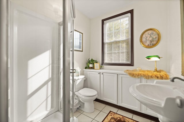 bathroom with tile patterned floors, sink, toilet, and walk in shower