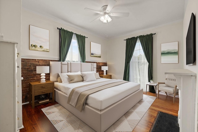 bedroom with hardwood / wood-style flooring, ceiling fan, and crown molding