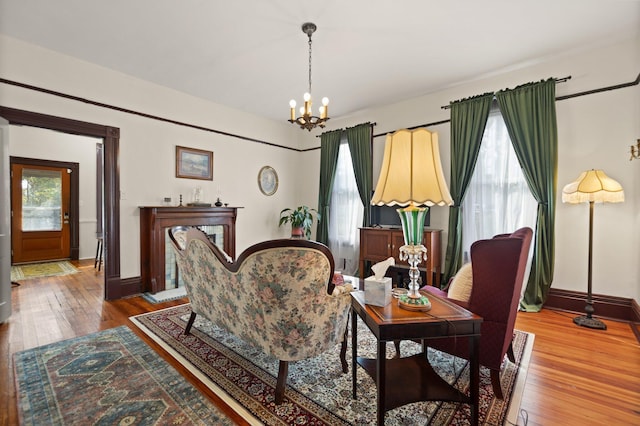 sitting room featuring a chandelier and hardwood / wood-style flooring