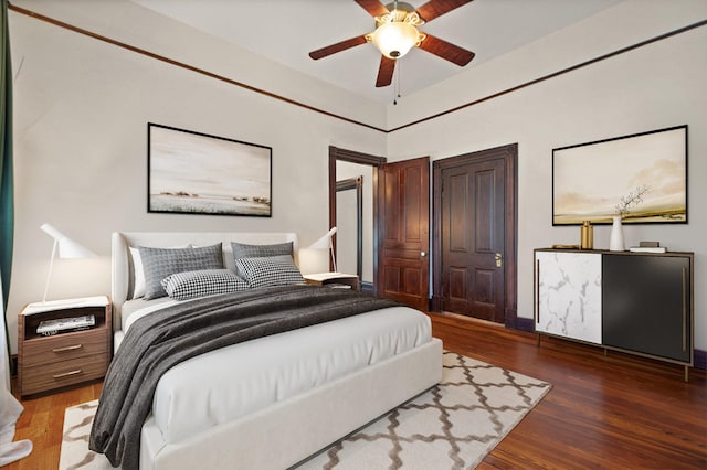 bedroom with ceiling fan and dark hardwood / wood-style floors