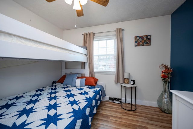 bedroom featuring wood-type flooring and ceiling fan