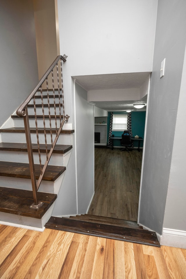 staircase with hardwood / wood-style floors