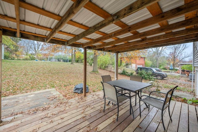 wooden terrace featuring a yard