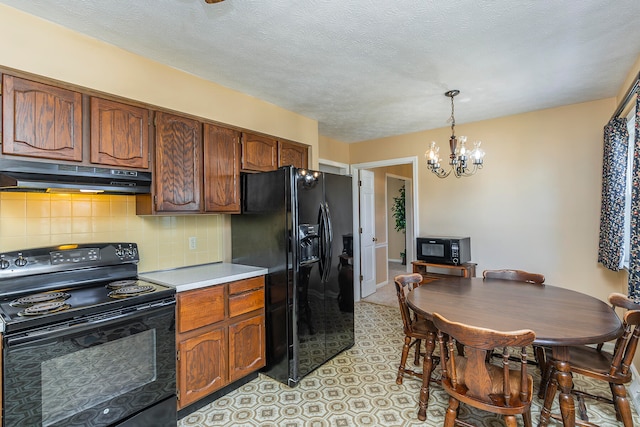 kitchen with decorative backsplash, a textured ceiling, black appliances, a notable chandelier, and hanging light fixtures