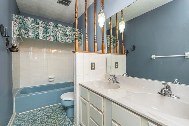 full bathroom featuring tasteful backsplash, tile patterned flooring, a textured ceiling, toilet, and vanity