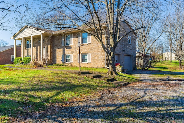 view of front of house featuring a garage and a front lawn