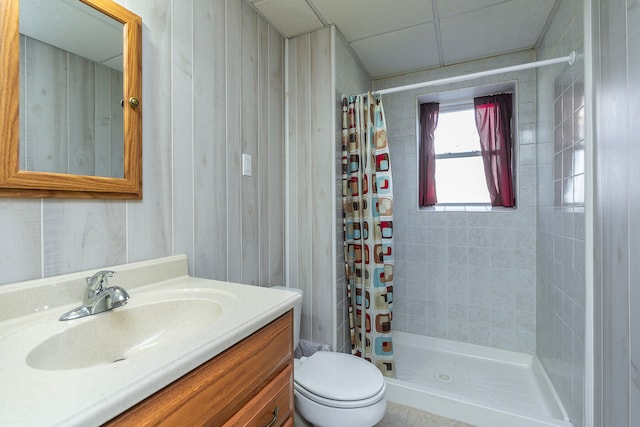 bathroom with tile patterned floors, vanity, toilet, and curtained shower