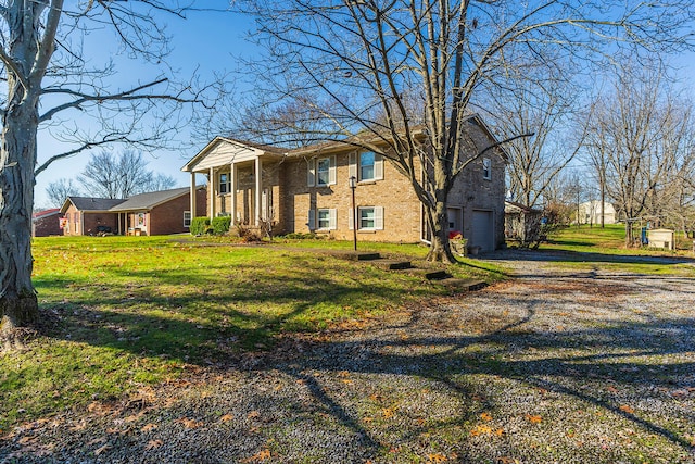 view of front of home featuring a garage and a front lawn