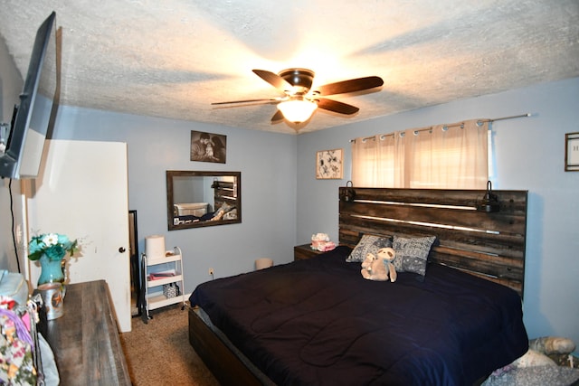 bedroom featuring carpet flooring, a textured ceiling, and ceiling fan