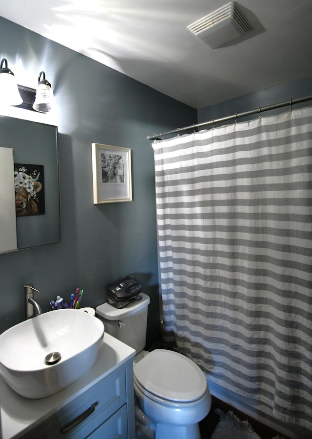 bathroom with vanity, toilet, and walk in shower