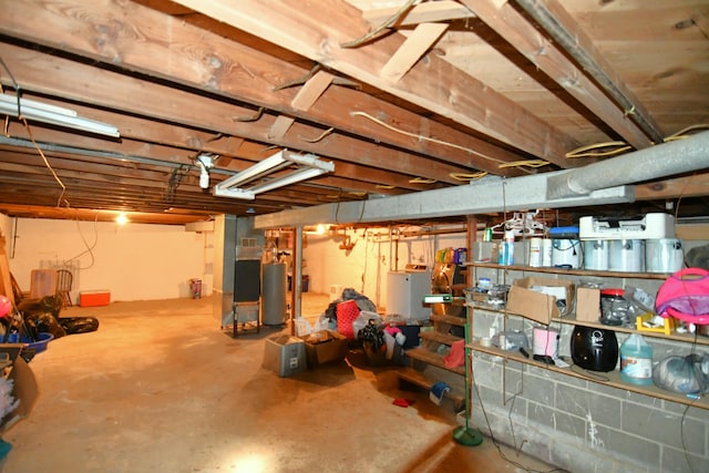 basement with gas water heater and washer / dryer