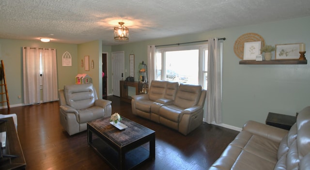 living room with dark hardwood / wood-style floors and a textured ceiling