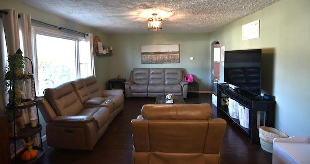 living room featuring dark hardwood / wood-style floors and a textured ceiling