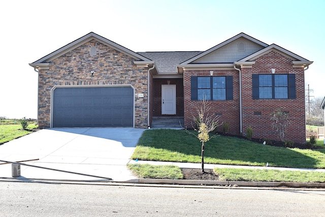 view of front of home with a front yard and a garage