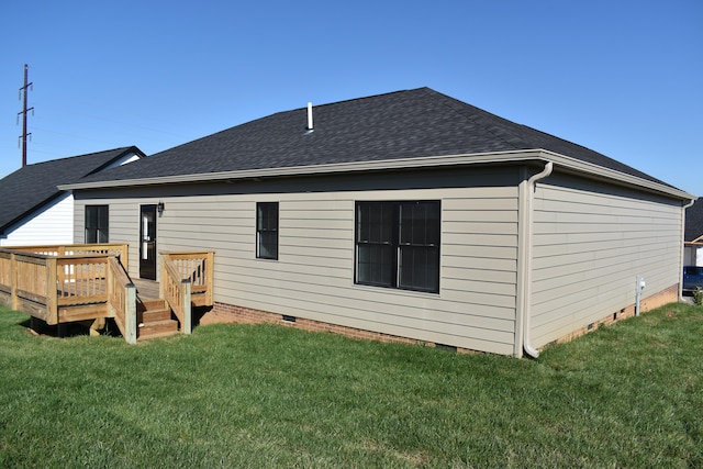 back of house with a deck and a yard