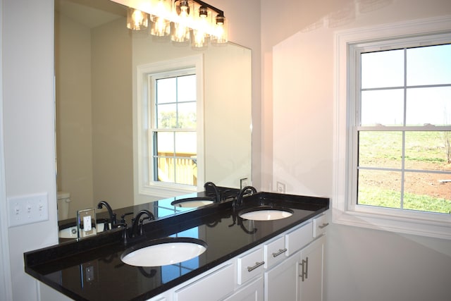bathroom featuring a wealth of natural light and a sink