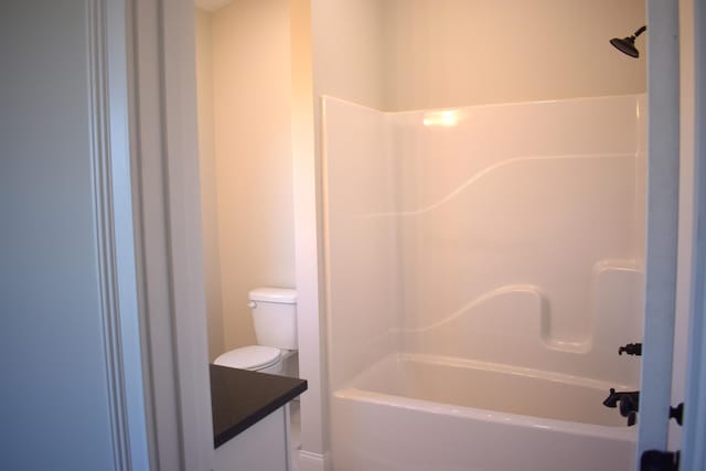 bathroom with shower / bathing tub combination and toilet