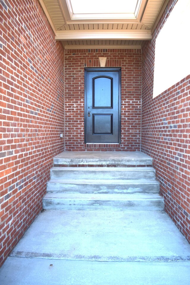 entryway with hardwood / wood-style flooring, ceiling fan, and vaulted ceiling