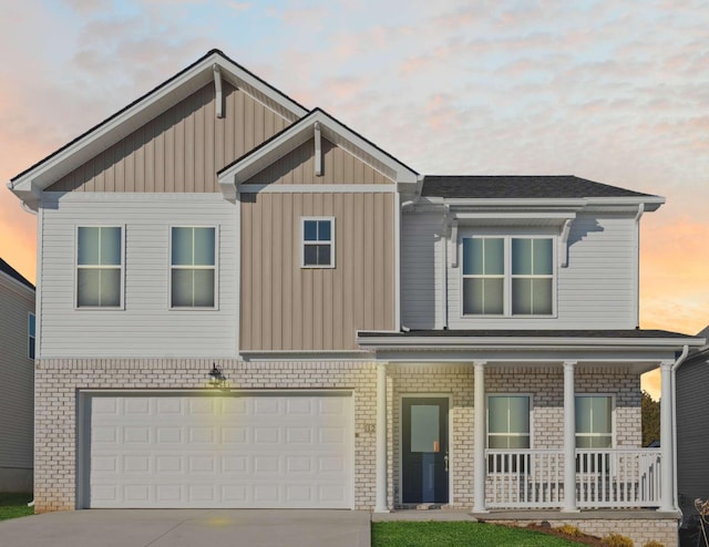 view of front facade with a porch, a garage, driveway, and board and batten siding