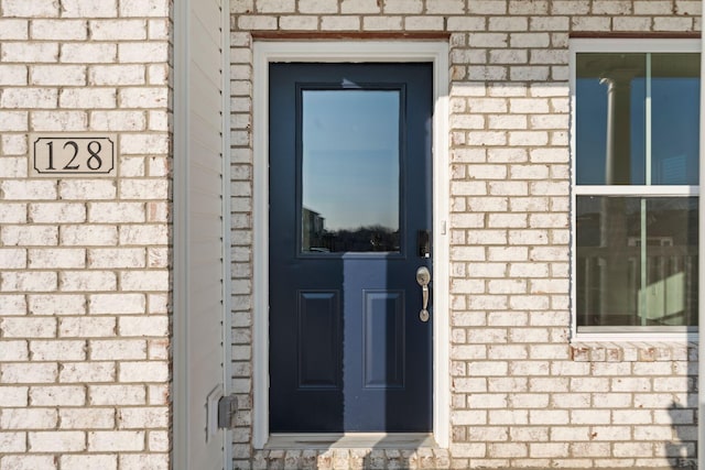 property entrance with brick siding