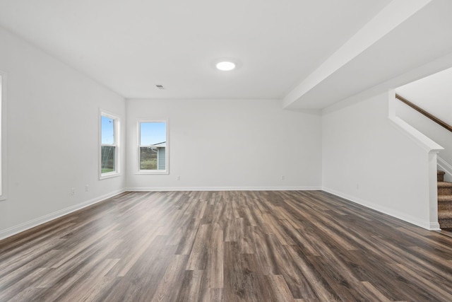 unfurnished living room with dark hardwood / wood-style flooring