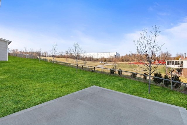 view of yard featuring a patio area, fence, and a rural view