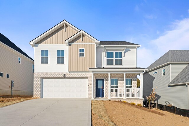 view of front of property featuring covered porch and a garage