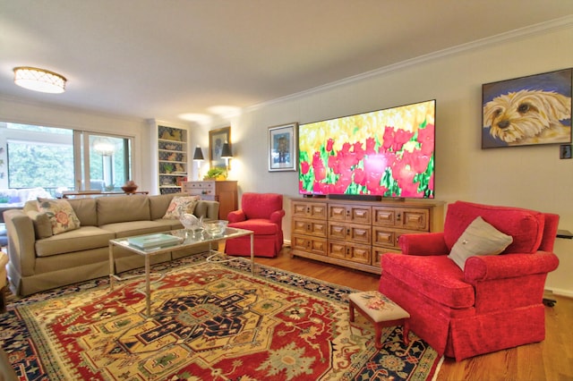 living room with wood-type flooring and ornamental molding