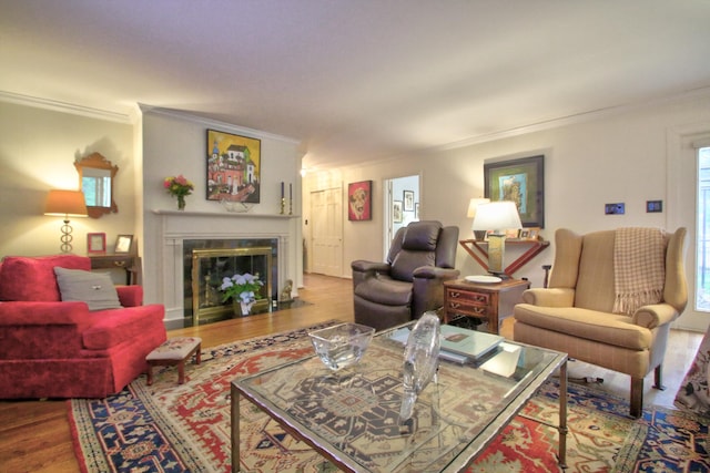 living room featuring wood-type flooring, plenty of natural light, and ornamental molding