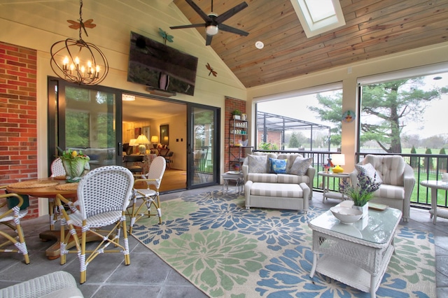 sunroom / solarium featuring lofted ceiling with skylight, wooden ceiling, and ceiling fan with notable chandelier