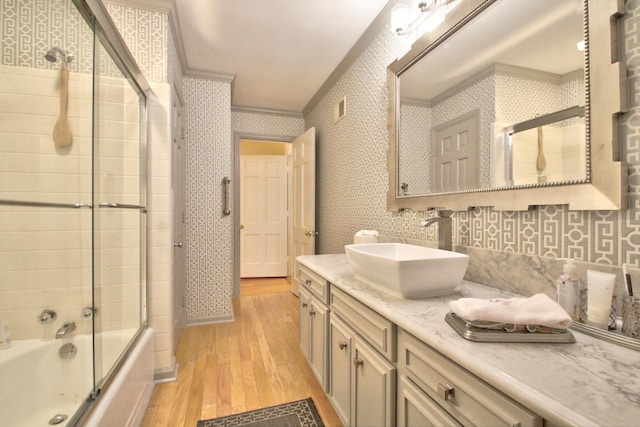 bathroom with enclosed tub / shower combo, crown molding, vanity, and wood-type flooring