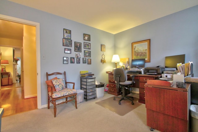 office area featuring light carpet