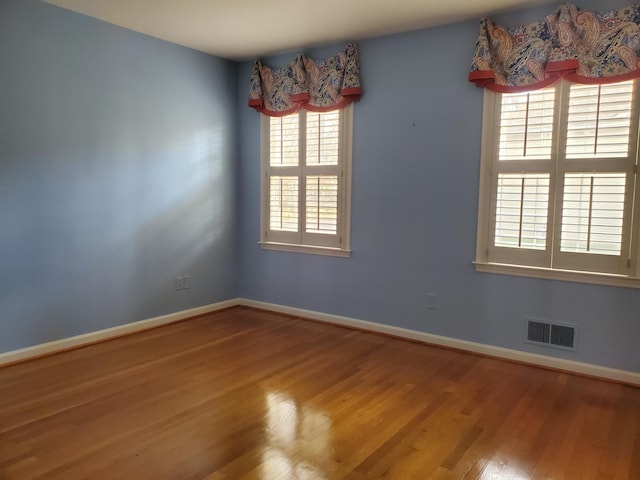 empty room with hardwood / wood-style flooring