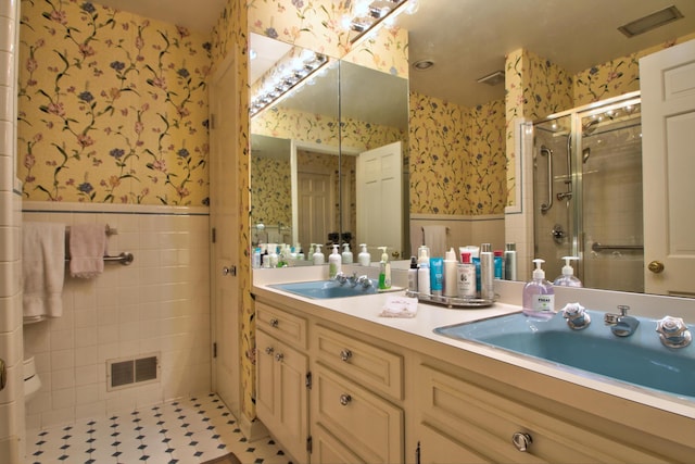 bathroom featuring vanity, tile patterned floors, and a shower with door