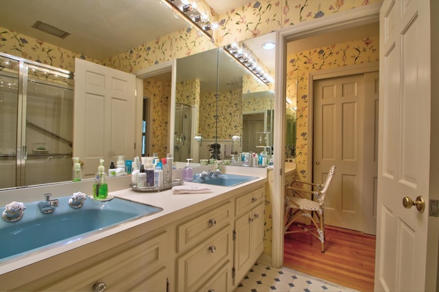 bathroom featuring a shower with door, vanity, and wood-type flooring