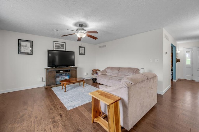 living room featuring a textured ceiling, dark hardwood / wood-style flooring, and ceiling fan