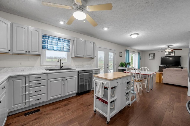 1063 Wades Mill Rd, Winchester, KY 40391 - kitchen featuring dishwasher, a ceiling fan, a sink, dark wood-type flooring, and a textured ceiling