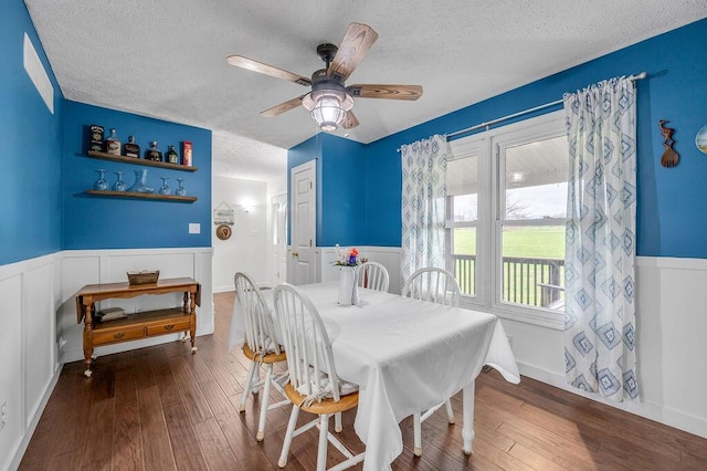 dining area featuring hardwood / wood-style floors, a textured ceiling, and ceiling fan