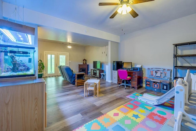 rec room featuring ceiling fan, french doors, and hardwood / wood-style flooring