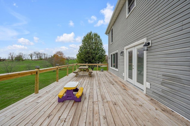 deck featuring french doors and a yard